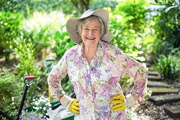 Happy senior woman standing in garden