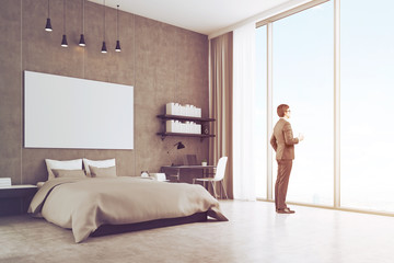 Side view of a young businessman near his bedroom window, toned