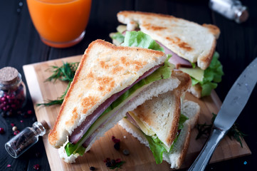 club sandwiches on wood background