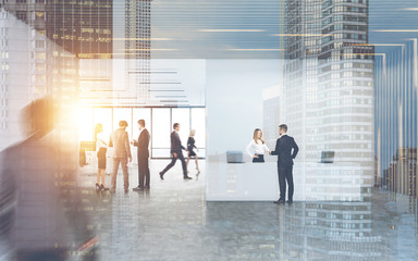 Man talking to a receptionist girl in a busy office
