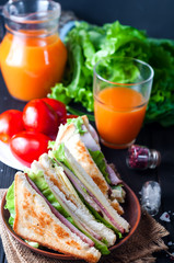 homemade sandwich with salad and juice as a healthy breakfast