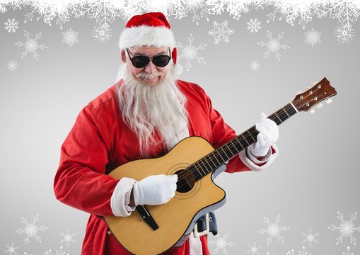 Santa claus in sunglasses playing guitar
