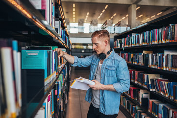 Handsome college student in library