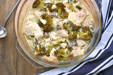 Roasted chicken meat with broccoli, cheese and cream in glass bowl