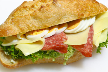 Baguette bun, salami, cheese, lettuce and boiled eggs