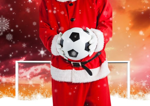 Santa claus holding a soccer ball