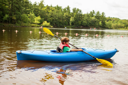 Boy paddling in a kayak