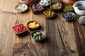 Assorted natural medical herbs and mortar