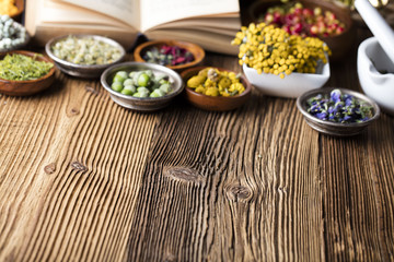 Assorted natural medical herbs and mortar