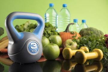 Diet and Fitness theme with healthy food. Place for typography and logo. Beautiful reflections. Bright blue background. Lots of vegetables, fruits and fitness equipment. Healthy lifestyle concept.