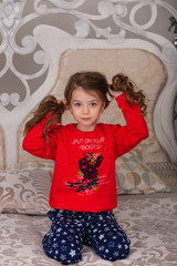 Fototapeta premium Sweet girl in pajamas getting ready for bed