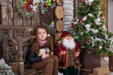 Beautiful girl posing in Christmas decorations