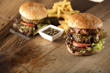 Fresh home-made hamburger served on wood, place for typography
