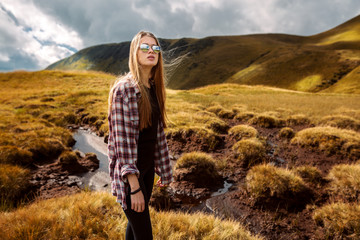 Shot of a young woman looking at the landscape while hiking in the mountains