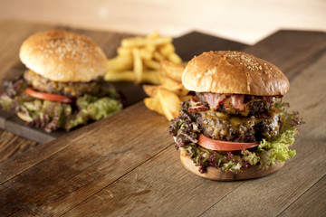 Fresh home-made hamburger served on wood, place for typography