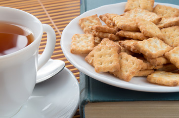 Detail of a cup of tea and a plate of crackers