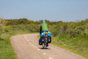 Cyclist on a bike path in the dunes Noordwijk