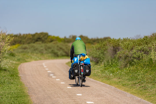 Cyclist on a bike path in the dunes Noordwijk