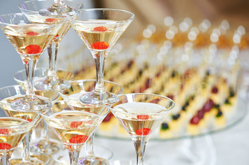 glasses with alcohol drinks in pyramid