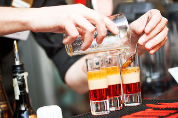 Barman or bartender preparing alcohol cocktail in restaurant