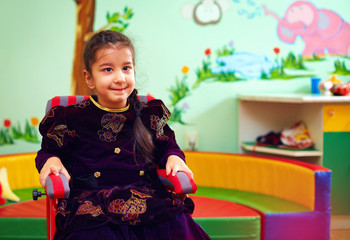 cute little girl in wheelchair at rehabilitation center for kids with special needs