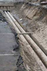 water pipes in ground pit trench ditch during plumbing under construction repairing