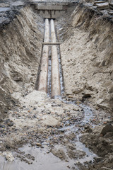 water pipes in ground pit trench ditch during plumbing under construction repairing