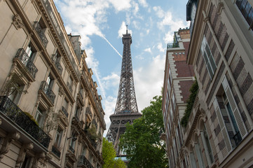 Fototapeta na wymiar The Eiffel Tower seen behind buildings in Paris, France