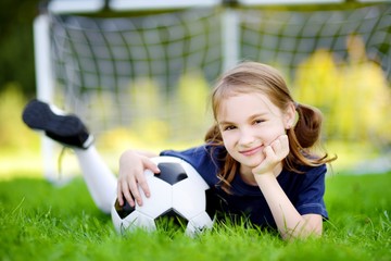 Cute little soccer player having fun playing a soccer game