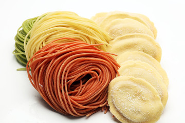Fettuccine and spaghetti with ingredients for cooking pasta on a white background, top view. Flat lay