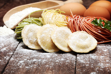 Fettuccine and spaghetti with ingredients for cooking pasta on a white background, top view. Flat lay