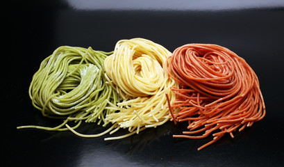 Fettuccine and spaghetti with ingredients for cooking pasta on a white background, top view. Flat lay