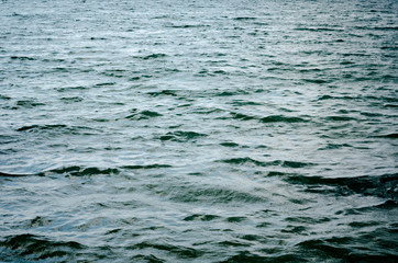 Dark blue background of water surface. Ocean water surface texture. Deep sea waves