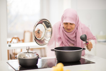 Arabic beautiful housewife making a lunch in kitchen