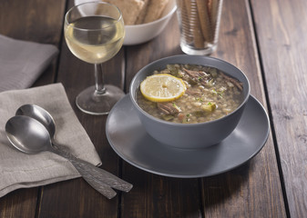 Meat soup with lemon, wine and bread