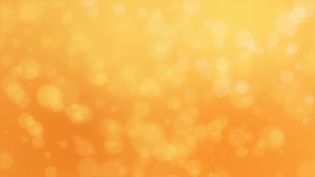 Bokeh holiday background with floating particles against a golden orange gradient backdrop