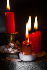 candles lit, colored dark / black / background - burning candle wax 