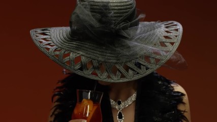 Glamour woman in big elegant hat with coctail . Shot on RED EPIC Cinema Camera. - Powered by Adobe