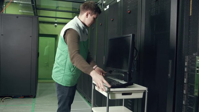 an Employee of the Data Center Working in the Server Room