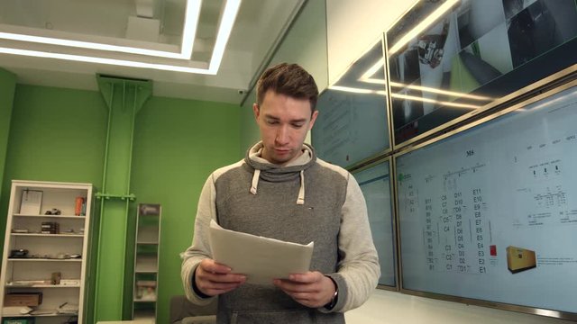 Clerk in the Office to Review the Document With Control Monitor