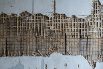 Old plaster wall in the house, straw, wood, plaster.
