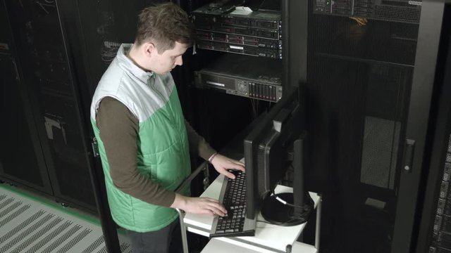 Specialist Configures Server Hardware in a Server Rack