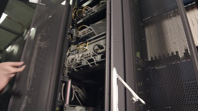 Two Employees of the Data Center Installing the Server Hardware