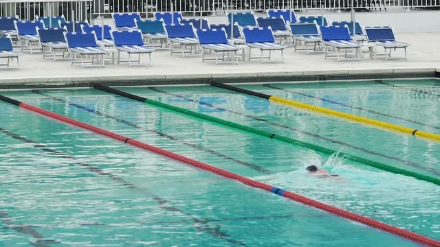 Confident person swimming in pool, training before professional competition