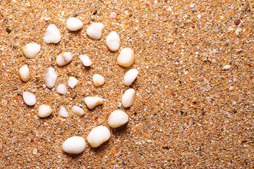 spiral of white rocks, on fine sand