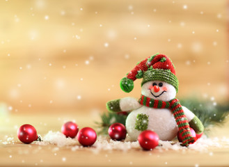 Fototapeta na wymiar Christmas background.funny snowman dressed as Santa Claus 