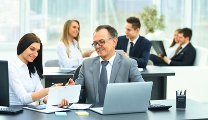 successful businessman and his assistant discuss the work plan 