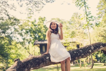 Young teen girl sitting on tree