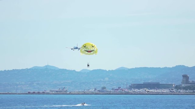 Thrilling parachute flight over sea, parasailing sport, tourists enjoying rest