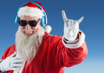 Santa claus listening music on headphones and gesturing